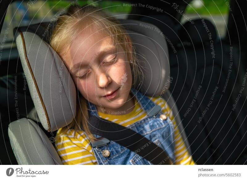 Caucasian girl sleeping during the road trip backseat blond daughter kid woman germany car child chair safety mother belt parent people travel sitting happy