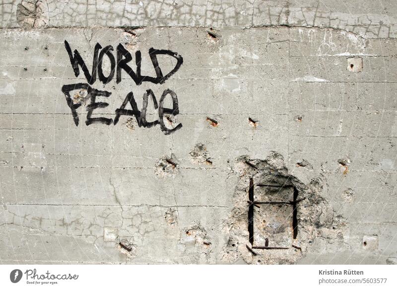 world peace lettering on a wall with ammunition impacts Peace Peaceful pacifism pacifist Graffiti street art Wall (barrier) Wall (building) Facade smash Target
