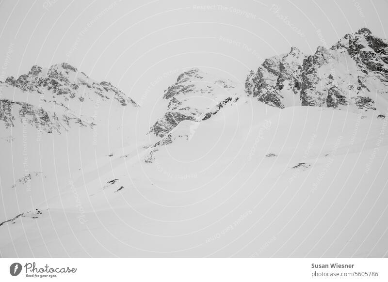Structures of mountains rise as if painted in a white and misty winter landscape Minimalistic Winter Snow Snowcapped peak Exterior shot Deserted black-white