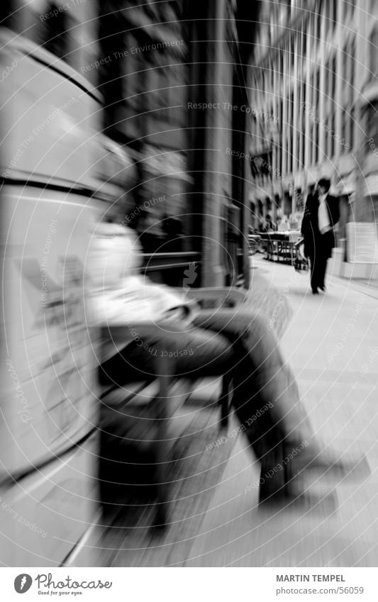 In peace lies strength. Black & white photo Exterior shot Blur Motion blur Woman Adults Legs Town Street Jacket Sit Sidewalk steep Bench