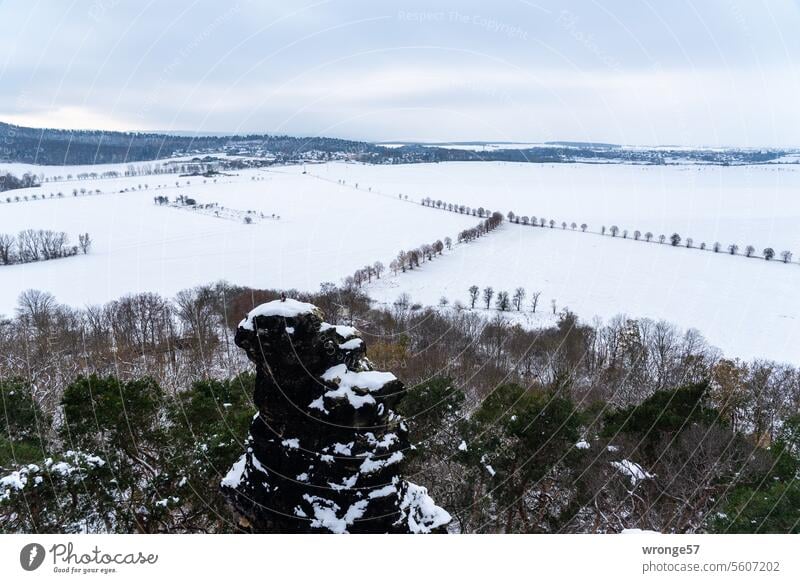 Snowy winter landscape with a village at the top of the picture and solitary rocks in the foreground Winter Snowscape Winter mood Winter's day Cold White