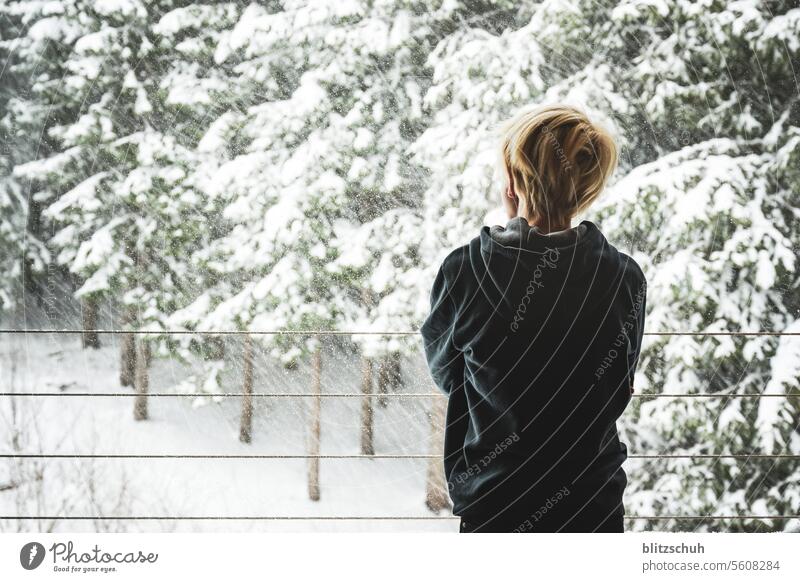 A boy at the window watches the snow fall Snow Winter Cold White Nature Winter mood Winter's day Snowscape Seasons chill Forest Winter forest Girl Joy sad