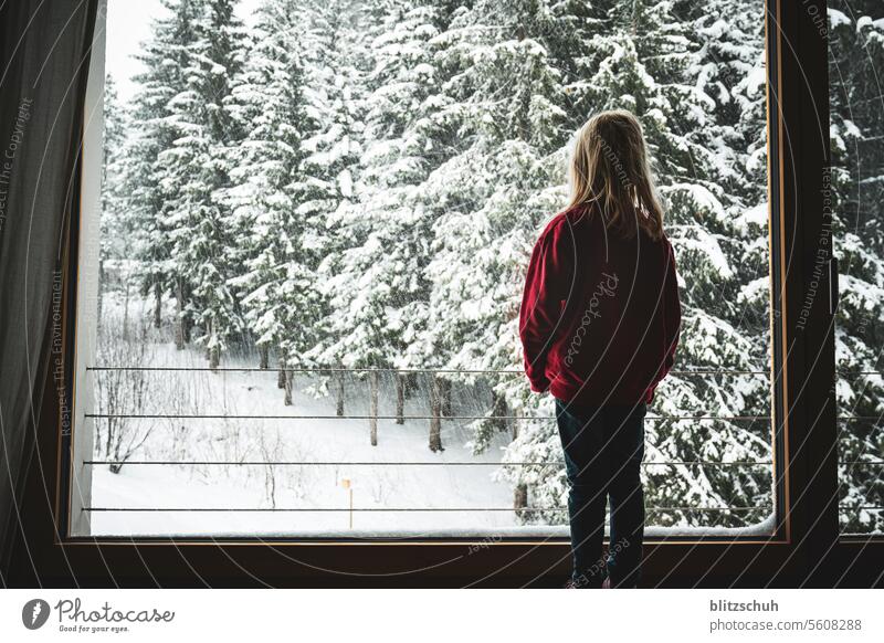 A girl at the window watches the snow fall Snow Winter Cold White Nature Winter mood Winter's day Snowscape Seasons chill Forest Winter forest Girl Joy sad