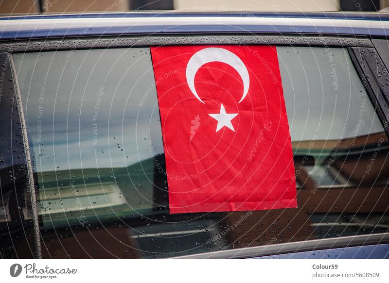 Turkish Flag hanging out the car window parked outdoor background star patriotic flag national celebration turkey turkish concept rainy vehicle automobile moon