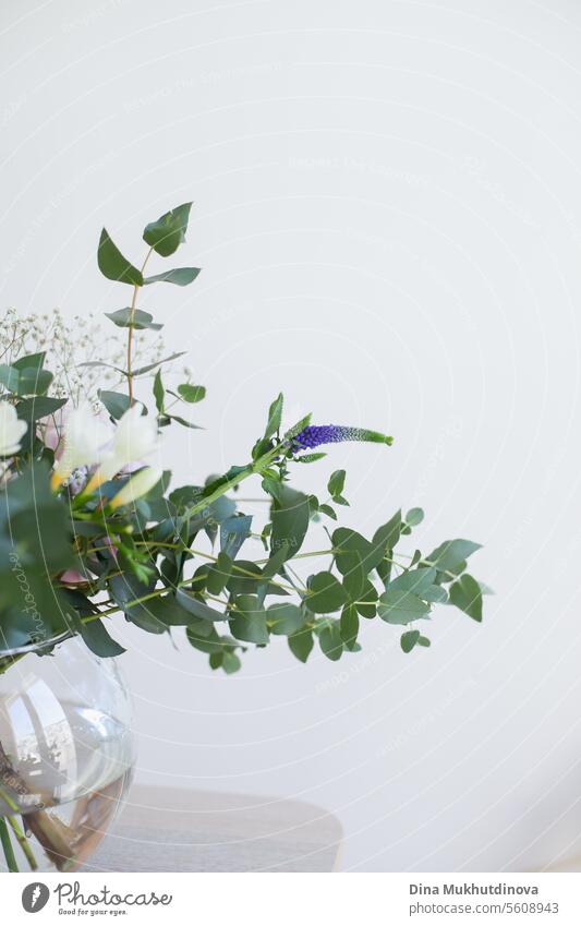 beautiful minimal bouquet with spring flowers and eucalyptus leaves. Fresh elegant home decor. Florist work. salon vase florist floristry leaf green minimalist
