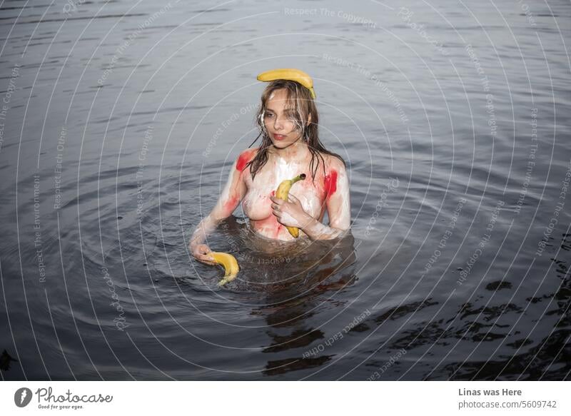 A gorgeous topless girl is sprayed with body paint and holding bananas. It’s quite unusual though she can’t hide her sexy curves. A naked swim in dark water. With a gorgeous nude girl. A wild beauty is feeling just fine in her skin.
