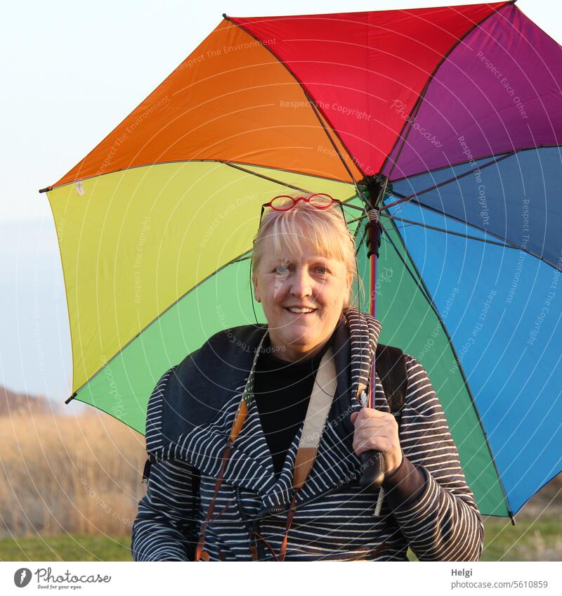 Cheerful senior citizen with colorful umbrella Human being Woman Adults Senior citizen portrait Upper body Face Looking into the camera Umbrellas & Shades