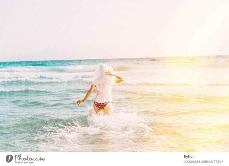 Beach Vacation Concept. Young, Pretty Lady Relaxing In Vacation. Active Caucasian Young Woman Goes Towards In Sea Ocean. Happy Seaside Vacation. Happy Beautiful Girl On Beach Vacation. Bright Summer