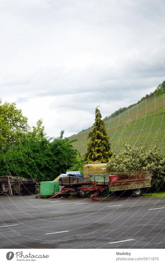 Old trailer for the tractor with tanks and containers on the farm of a winegrower in the vineyards of Traben-Trarbach on the Moselle in the district of Bernkastel-Wittlich in Rhineland-Palatinate