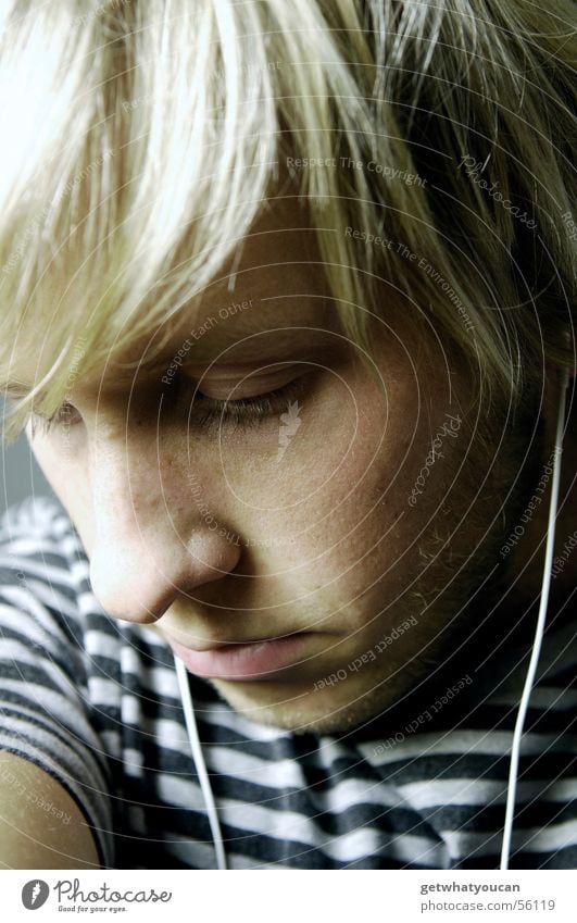Beautiful melancholy Man Headphones MP3 player Grief Thought Under Negative Cold Gray Dark Face Looking Music Sadness Hair and hairstyles Pallid