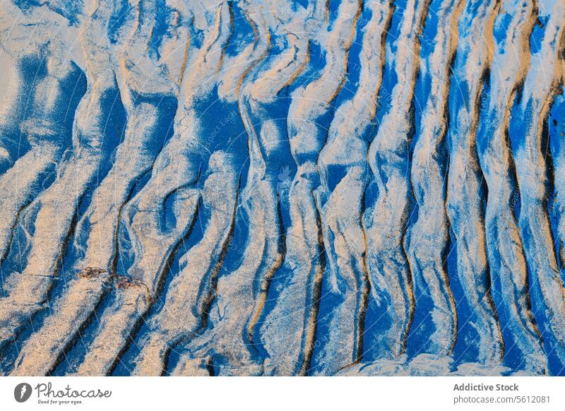 Abstract sand patterns with blue shadows abstract texture natural art wavy light shade form design background surface curve earth grainy granular close-up macro