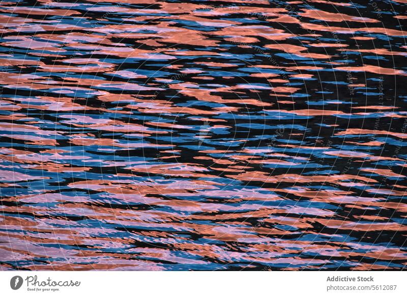 Abstract rippled water texture in sunset colors abstract reflection pattern warm hue tranquility nature background surface wave calm serene liquid natural wavy