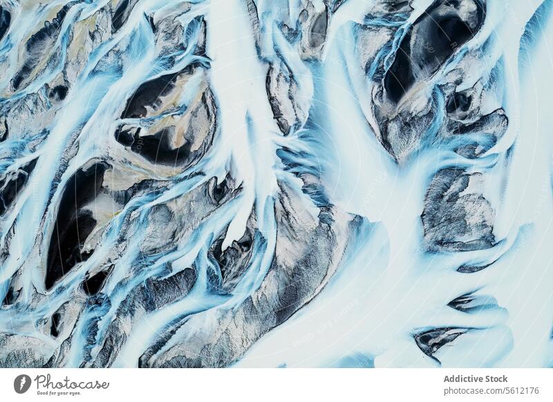 Aerial Patterns of a Frozen River Basin in Iceland aerial iceland river basin frozen pattern snow landscape nature abstract winter cold blue white texture