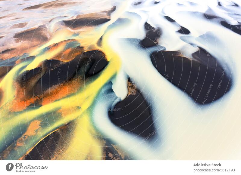 Aerial View of a Colorful River Basin in Iceland aerial iceland river basin abstract patterns vibrant colors intermingling landscape nature water flow geology