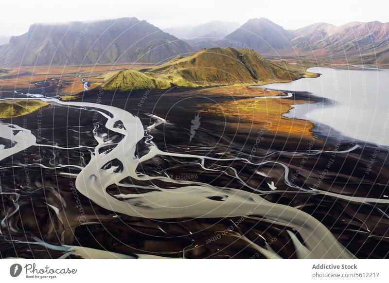 Aerial view of Iceland's meandering river basins iceland aerial view landscape natural beauty mountain backdrop winding scenic outdoor terrain earth waterway