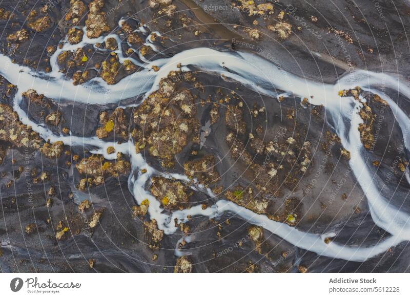 Aerial view of a river basin in Iceland's rugged terrain iceland aerial landscape volcanic pattern intricate water stream nature natural beauty earth texture