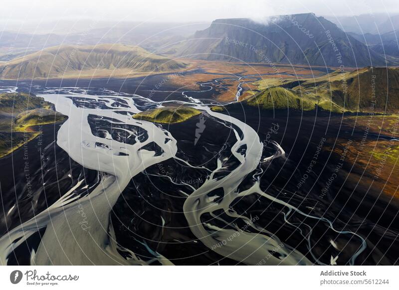 Aerial view of winding river through Icelandic landscape iceland aerial view volcanic mountain meandering nature beauty majestic terrain flow water natural