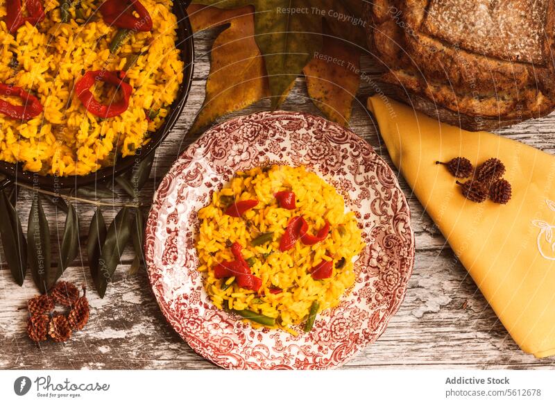 Traditional rice dish served with cheese and rustic bread paella table wood slice wedge meal colorful garnish vegetable presentation serving tradition cuisine