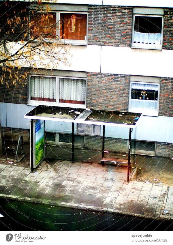 bus stop Bus stop House (Residential Structure) Window Curtain High-rise Tree Dirty Asphalt Trash Loneliness Water