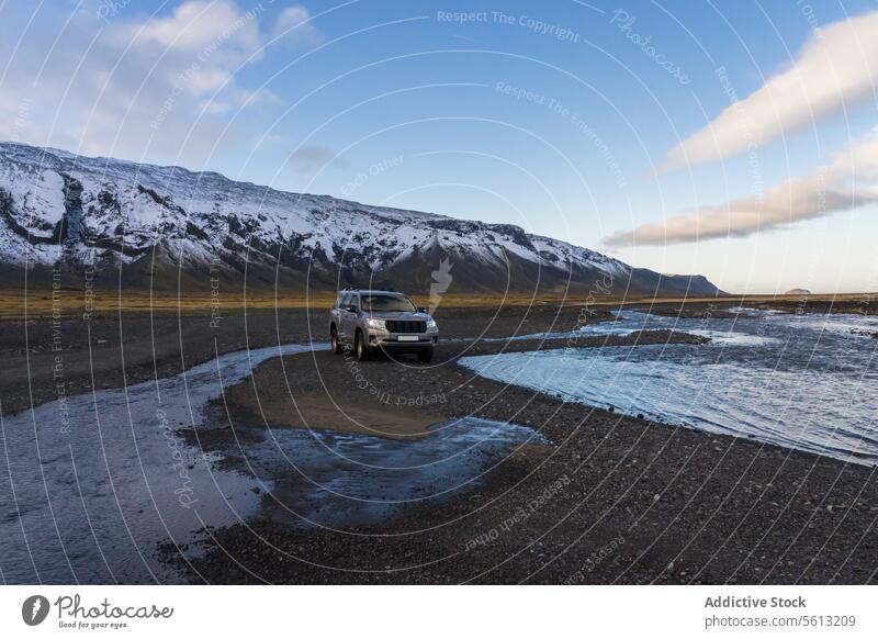 Off-road vehicle adventure in Iceland's Thorsmork valley near river against snowy mountains iceland highlands thorsmork off-road fording snow-capped clear