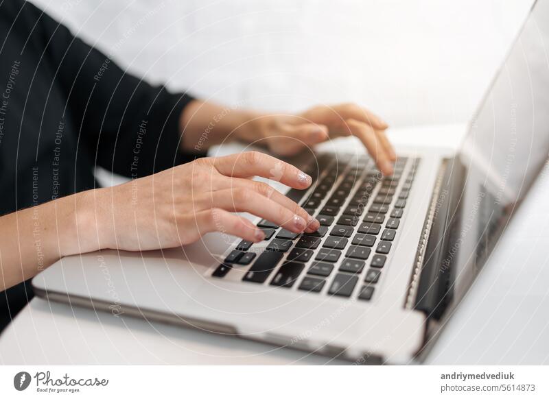 Close up woman's hands typing on laptop keyboard at home office. Businesswoman or student girl using pc for online internet marketing, freelance, work from home, education online, distance studying