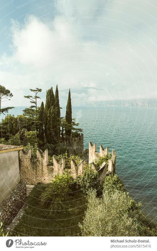 View from the slope over the planted castle battlements to Lake Garda Lago Italy Lombardy Water Harbour seascape port picturesque lake view pastel pastel shades