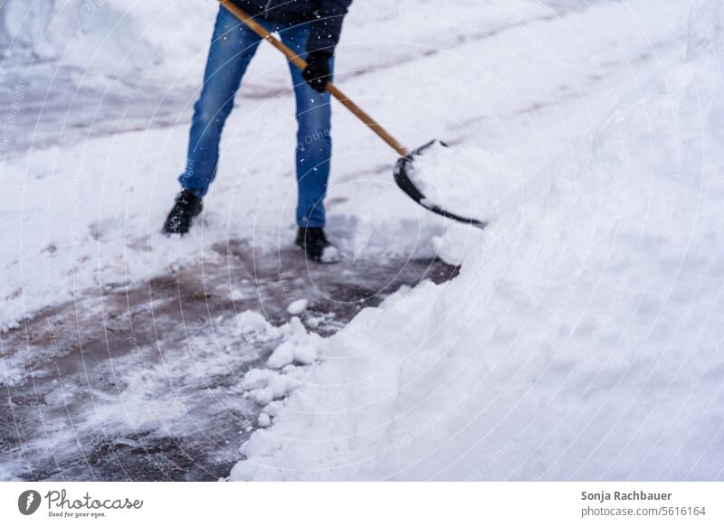 A man clears a sidewalk with a snow shovel Winter Winter's day onset of winter Man partial view December Winter mood Weather Cold Walkways Environment White