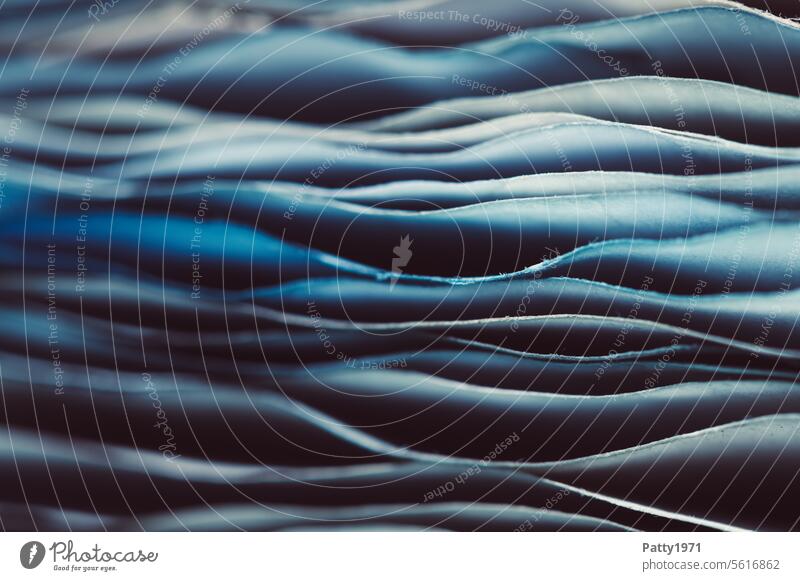 Wavy, blue stack of paper. Macro shot Paper Stack Undulating edge shape Close-up Blue Detail Line Structures and shapes Old vintage Rough Abstract Pattern macro