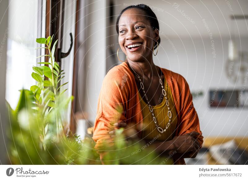 Portrait of a smiling mature woman standing in her apartment people joy black natural attractive black woman happiness happy real people adult daily life adults
