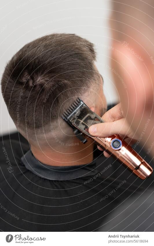 Haircut and adjustment of the head contour with a hair clipper (trimmer). Short haircut in the hairdressing salon. stylish Hairdresser barbershop Style Fashion