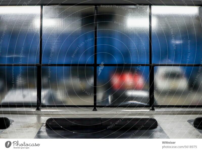 You can see some cars parked in the underground parking garage through a glass wall Parking Parking garage Garage Car Vehicle Transport Passenger traffic