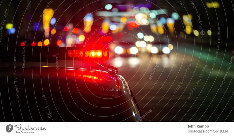 police car lights in night city with selective focus and bokeh abstract accident alarm scene news emergency road crime service red law enforcement urban duty