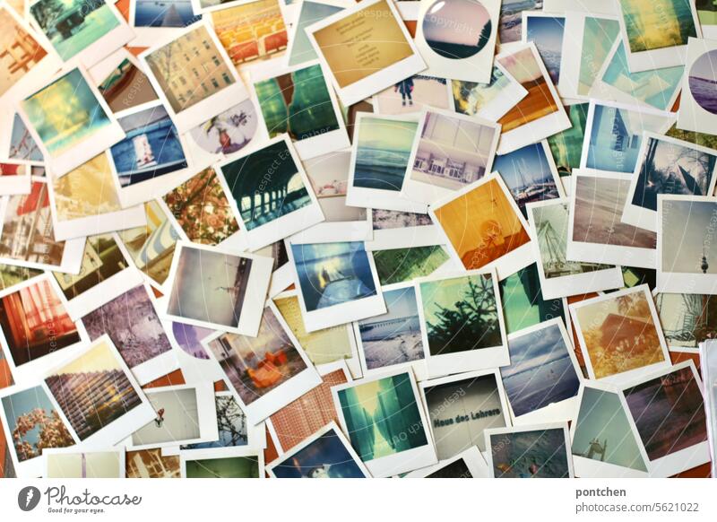 Many Polaroid photographs lie on the floor. Memories, hobby. Photographs Collection Memory Colour photo Past Nostalgia Analog Sentimental Retro Flat