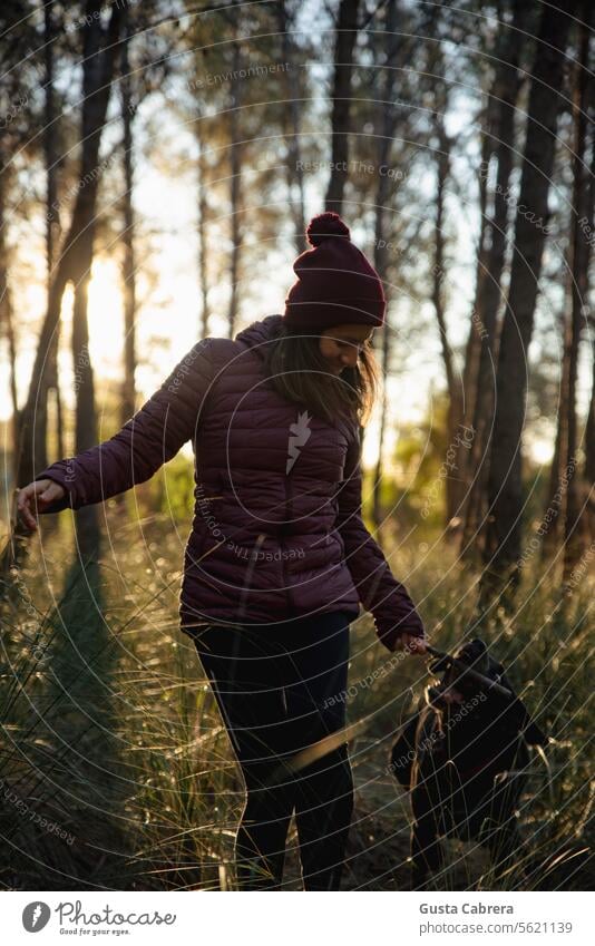 Woman enjoys her pet during her daily walk. Dog Pet enjoying life enjoy life Forest Trees trees forest Trees in the background Environment Exterior shot