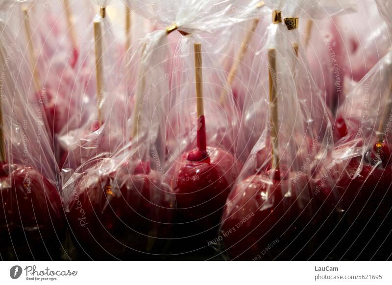 Candied apples in foil candied apples Red Packing film Apples on a stick handle Christmas Fair Fairs & Carnivals candy Candy sweets Sweets to go Fruit cute
