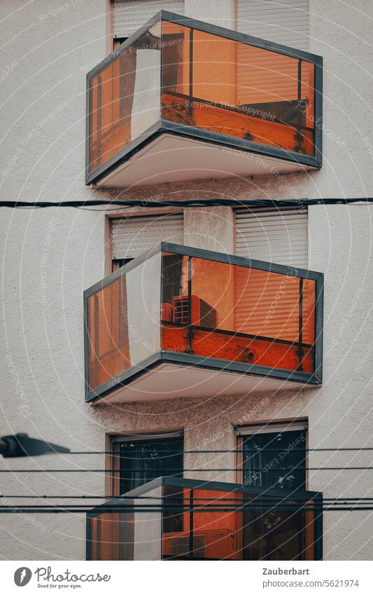 Triangular glazed balconies in orange on a modern building façade Balcony triangular Glass Orange structure Architecture dwell Flat (apartment) Living world