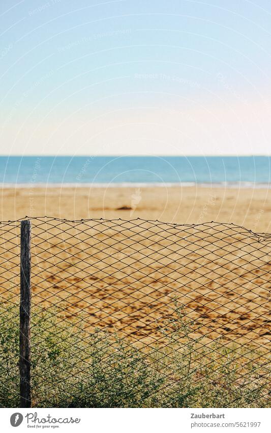 Beach, a wire mesh fence in front of it, longing Fence Wire netting idyll Disturbed Disturbance reality actuality vacation Barrier Ocean Border Protection