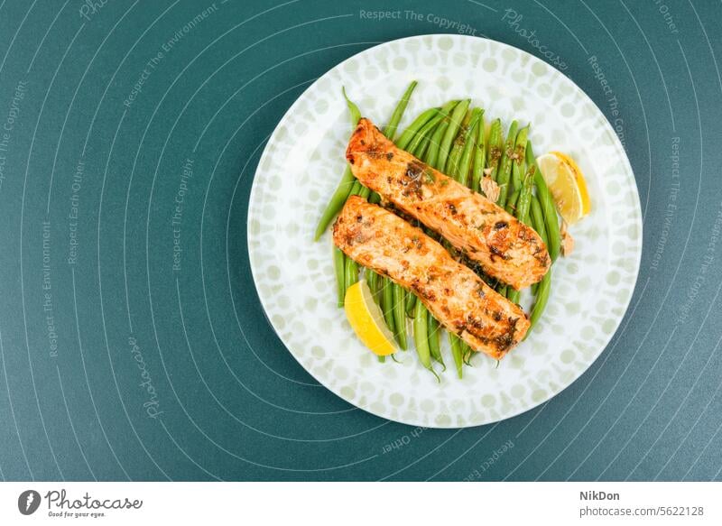 Baked salmon with green or bush beans. seafood fish steak filet baked trout fillet grilled plate green beans vegetable lemon diet roasted prepared fried