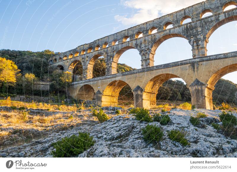 The magnificent Pont du Gard, an old Roman aqueduct bridge, at sunset. Photograph taken in Provence, South of France Ancient Aqueduct Arch Architecture Autumn