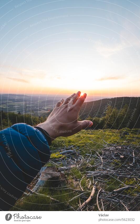 Catching the sunset between your fingers on the top of a mountain, Beskydy mountains, Czech Republic freedom silhouette sunrise harmony glowing gesture person