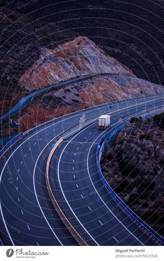 Truck with refrigerated semi-trailer driving on an empty highway, top view. transport truck curve traffic transit freight logistic lorry cargo turn freeway