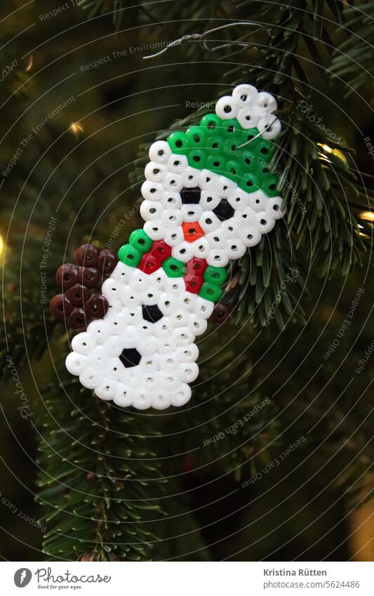 snowman made of iron-on beads hangs on the christmas tree Snowman Christmas tree decorations craft beads Handicraft christmas decoration Fir tree fir branches