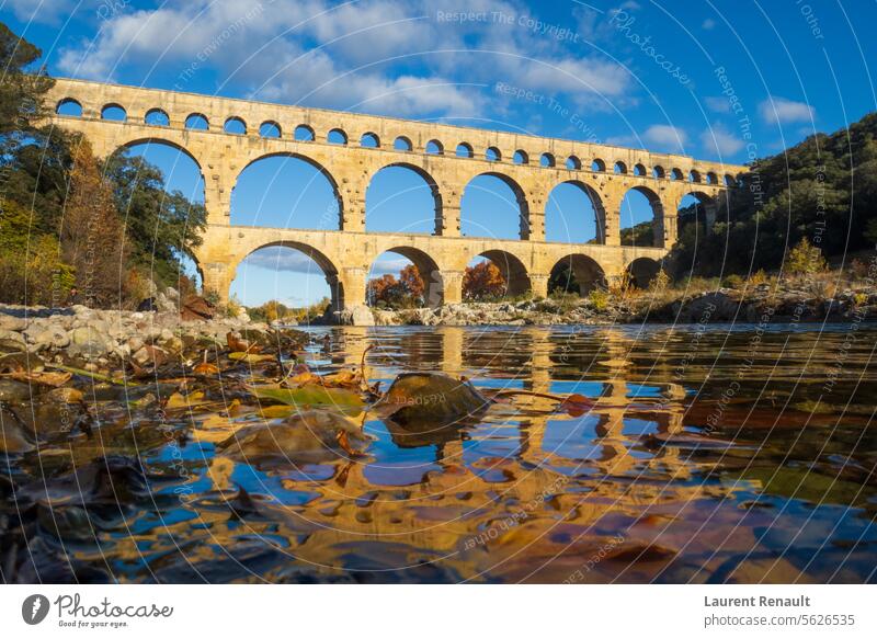 The Pont du Gard viewed from the river. Ancient Roman aqueduct bridge. Photography taken in Provence, southern France ancient arch architecture autumn culture