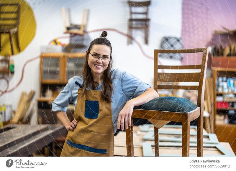 Portrait of a confident female carpenter standing in her workshop Furniture Carpenter Restoring Carpentry wood Chair building Manufacturing Craft Renovation