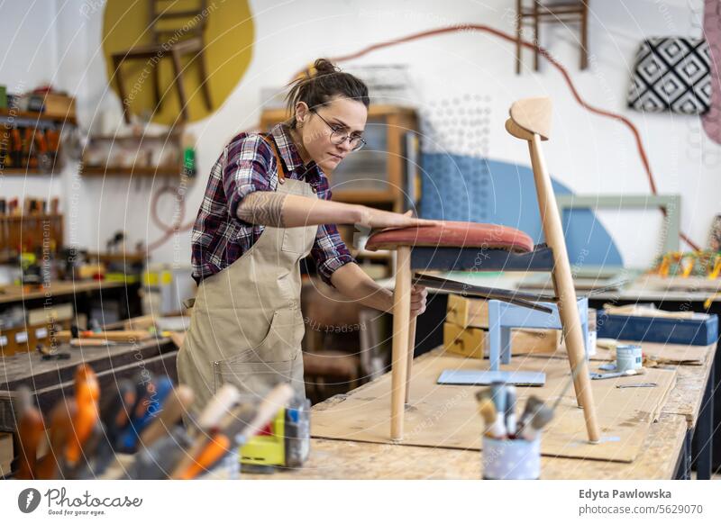 Female carpenter working in her workshop Furniture Carpenter Restoring Carpentry wood Chair building Manufacturing Craft Renovation Repairing Craftsperson