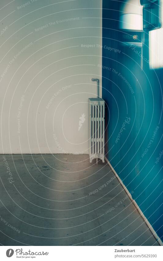 A heater in the corner of an empty room with white and blue walls and gray screed Heating Wall (building) White Blue Screed Gray angles Corner geometric Heater
