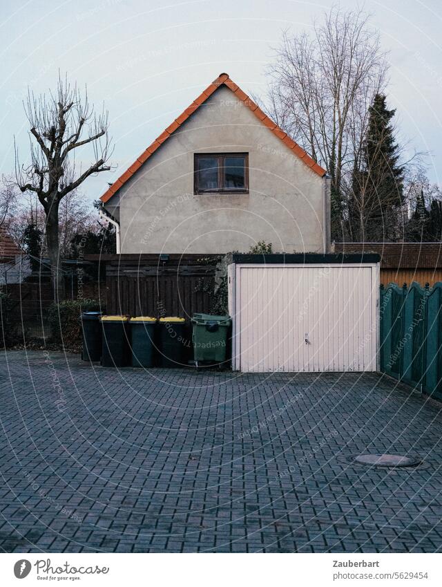 House in a small town with garage, garbage cans and the dream of a beach under the pavement House (Residential Structure) Small Town Garage dustbin Everywhere