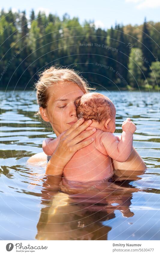 Mother swims with her baby girl in a summer lake Acclimatization Young Adult acclimation alfresco alternative bath bathe bathing camping child cold hardening