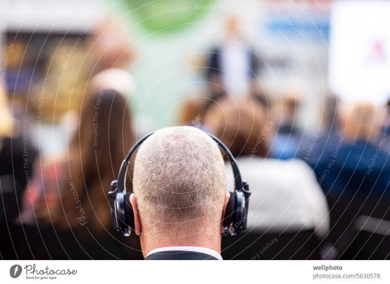Man using translation headphones during international political meeting, business conference, presentation or press conference speech event diplomacy
