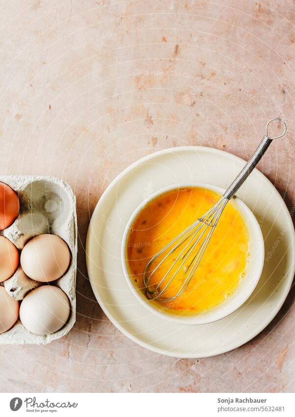 Beat the eggs in a bowl with a whisk. Top view. Scrambled eggs Preparation Breakfast plan Eggs cardboard Fresh Nutrition Eggshell Diet Protein Raw Organic
